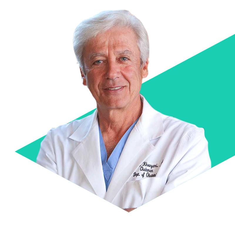 Photo of Dr. Victor Khouzami in front of a green stripe